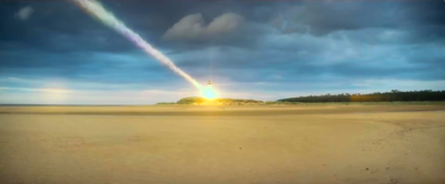 a cloud of smoke like a comet crashes into a lighthouse on a beach