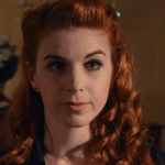 violet, a woman with long curly red hair