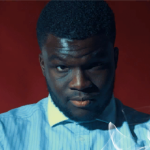 zak, a man with very short hair wearing a light blue dress shirt